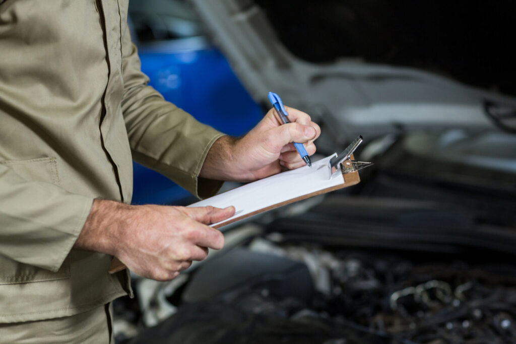 A man is holding a checklist inspection to double check the issues before purchasing the unit.